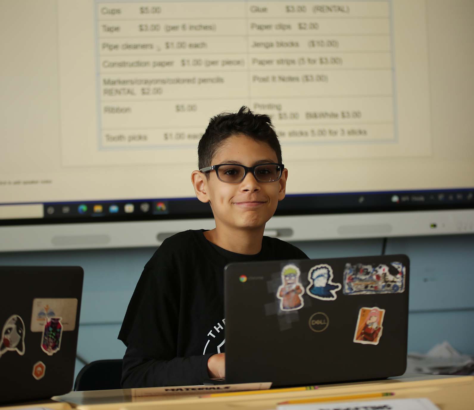 Noble Academy Columbus student wearing headphones uses a laptop in class