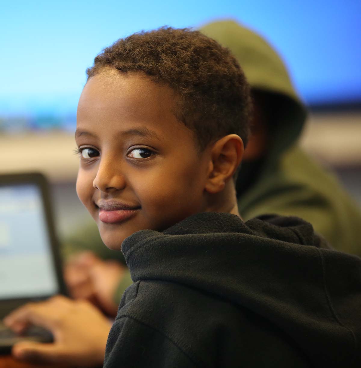 Student drawing in a classroom.