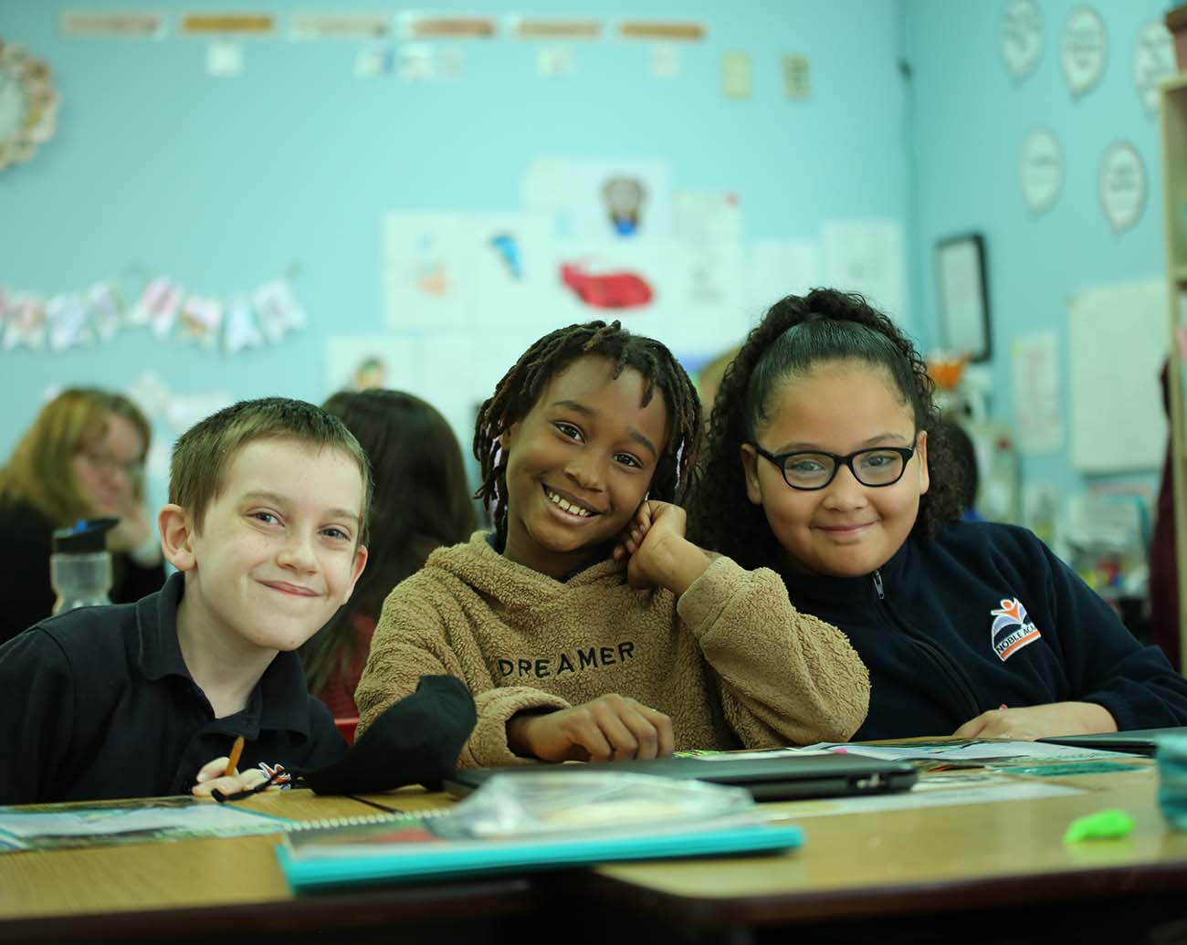 Teacher or school staff member warmly interacting with a student outside
